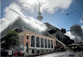  ?? CHRIS MCKEEN/STUFF ?? Firefighte­rs continue to pour water on to the fire which has badly damaged the SkyCity Convention Centre in Auckland. It is not yet clear what the economic fallout will be.