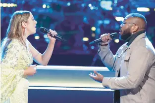  ?? TYLER GOLDEN/NBC ?? Magnus Martin, right, performs a duet of “Your Song” by Elton John with competitor Alyssa Lazar in Season 23 of “The Voice.”