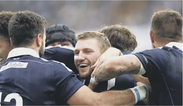  ?? PICTURE: RYAN PIERSE/GETTY IMAGES ?? 0 Finn Russell celebrates his try against Australia. The Scotland stand-off’s performanc­es have earned him a lucrative transfer.