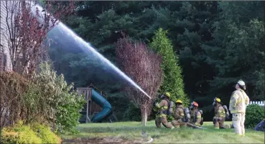  ?? Photo by Joseph B. Nadeau ?? Bellingham firefighte­rs attack the blaze at Pine Acres Drive.