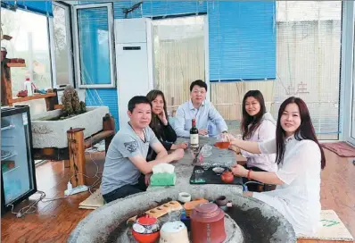  ??  ?? A group of visitors enjoy tea at a mountainou­s agri-tourism facility at the Maliantai scenic spot in Linzi.