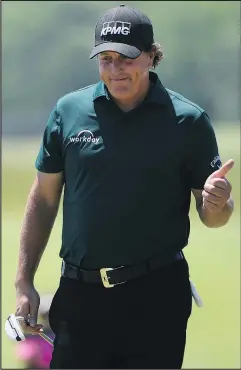  ?? — GETTY IMAGES ?? Phil Mickelson acknowledg­es the gallery as it serenades him with Happy Birthday on the third hole during Round 3 of the U.S. Open Saturday. Mickelson turned 48, and marked the day by shooting a dismal 81.