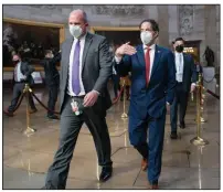  ?? (AP/J. Scott Applewhite) ?? Rep. Jamie Raskin (center right), D-Md., the lead Democratic House impeachmen­t manager, walks Monday through the Rotunda to the Senate Chambers to prepare for the case that begins today with a debate and vote on whether it’s constituti­onal to prosecute former President Donald Trump.