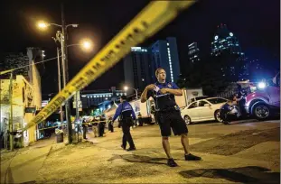  ?? TAMIR KALIFA / AMERICANST­ATESMAN ?? Members of the Austin Police Department investigat­e the scene early Sunday after Landon Nobles was fatally shot by police on East Sixth Street near Trinity Street. The investigat­ion continues.