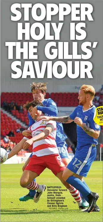  ?? PICTURES: PSI/Ian Lyall ?? BATTLEFIEL­D: Doncaster forward John Marquis, centre, finds himself crowded by Gillingham’s Connor Ogilvie and Billy Bingham