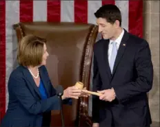  ?? Andrew Harrer/Bloomberg News ?? On Oct. 25, 2015, then House Minority Leader Nancy Pelosi, D-Calif., hands the Speaker's gavel to House Speaker-elect Paul Ryan, R-Wis., at the U.S. Capitol.