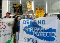  ??  ?? In this March 2018 file photo, supporters of temporary protected status of immigrants cheer as they hold signs and banners with the outline of El Salvador at a rally at a federal courthouse in San Francisco. Immigrants from Honduras and Nepal have filed a lawsuit alleging the Trump administra­tion unfairly ended a program that lets them live and work in the United States. AP PhoTo/JeFF ChIu