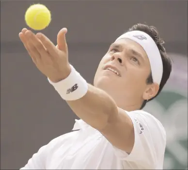  ?? The Associated Press ?? Canada's Milos Raonic serves to Spain’s Albert Ramos-Vinolas during their men’ singles match at the Wimbledon Tennis Championsh­ips in London on Saturday.