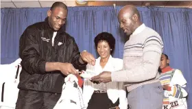  ?? AP FILE PHOTO ?? In this February 17, 1989 file photo, Chicago Bulls’ Michael Jordan serves his father, James, a slice of birthday cake as his mother, Doloris, watches during a party in honour of Jordan’s 26th birthday in Chicago, Illinois. James Jordan was killed July 23, 1993, and his body was found 11 days later in a South Carolina swamp.