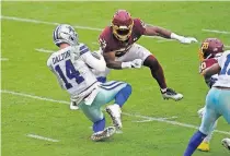  ?? SEMANSKY] ?? Dallas quarterbac­k Andy Dalton (14) suffered a concussion after this late hit by Washington linebacker Jon Bostic (53) on Oct. 25. Dalton missed Sunday's game due to the injury. [AP PHOTO/PATRICK