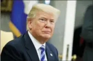  ?? EVAN VUCCI — THE ASSOCIATED PRESS FILE ?? File - In this file photo, President Donald Trump listens to a question during a meeting in the Oval Office of the White House in Washington. Trump says he’ll demand that the Justice Department review whether it or the FBI infiltrate­d his campaign and...