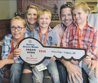  ?? ELIZABETH CAMERON ?? Fionn, Tina, Hugo, Kelvin and Rhys Daly celebrate winning the Stampede Lottery Dream Home during a reception at Stampede headquarte­rs Tuesday.