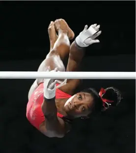  ?? ?? Simone Biles, a seven-time Olympic medalist and the 2016 Olympic champion, practices on the uneven bars at the U.S. Classic gymnastics competitio­n Friday, Aug. 4, 2023, in Hoffman Estates,
Ill. (AP Photo/Morry Gash)