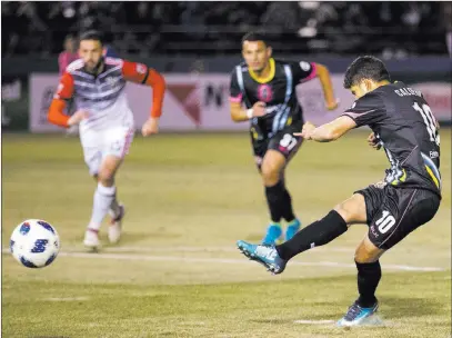  ?? Erik Verduzco ?? Las Vegas Review-journal @Erik_verduzco Las Vegas Lights FC forward Juan Jose Calderon, right, scores on a penalty kick during the second half of the Lights’ 4-2 loss to D.C. United on Feb. 24 at Cashman Field.