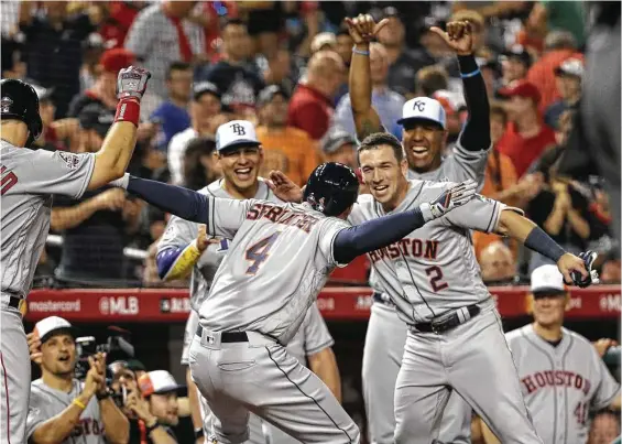  ?? Patrick Smith / Getty Images ?? George Springer, left, and Alex Bregman have a lot to celebrate in the 10th inning after both Astros produce home runs to lead the AL to victory Tuesday night.