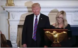  ?? THE ASSOCIATED PRESS ?? President Donald Trump smiles as pastor Paula White prepares to lead the room in prayer during a dinner for evangelica­l leaders in the White House in August 2018.