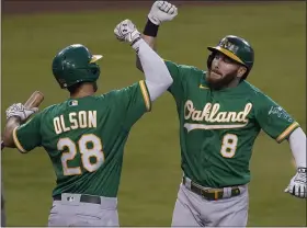  ?? ASSOCIATED PRESS FILE PHOTO ?? Oakland Athletics’ Robbie Grossman, right, celebrates his solo home run with teammate Matt Olson in a 2020 game. Grossman has inked a two-year deal with the Detroit Tigers.