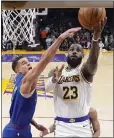  ?? MARK J. TERRILL — THE ASSOCIATED PRESS ?? Laker star Lebron James scores versus Denver, becoming the first NBA player to reach 40,000 career points.