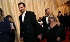  ?? Valerie Macon/AFP via Getty Images ?? Bradley Cooper and his mother Gloria Campano on March 10 at the 96th Annual Academy Awards.