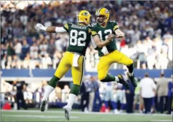  ?? THE ASSOCIATED PRESS ?? Richard Rodgers (82) and Aaron Rodgers (12) celebrate the winning touchdown in final seconds of the second half of Sunday’s game against the Cowboys. the