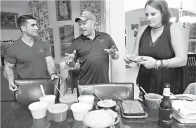  ??  ?? above Mohammed “Jay” Younus Yousafzoy, 24, listens to Jordan Step talk about Texas barbecue as his wife, Meghan, prepares a plate Nov. 29 in Houston. Yousafzoy—who also goes by “Jay”—had begun translatin­g for American-led forces in 2011, when he was 17. He started working as Hudson’s interprete­r in 2013.