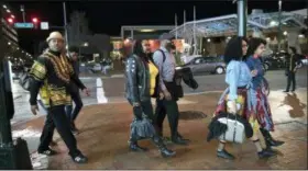  ?? SAIT SERKAN GURBUZ — THE ASSOCIATED PRESS FILE ?? Emanuel Lawton, left, and his family dressed in Wakanda-inspired attire arrive to see Black Panther in Silver Spring, Md.