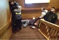  ?? YOUTUBE ?? Footage appears to show officers dragging an elderly man down a flight of stairs.