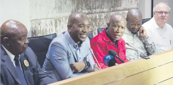  ?? Picture: AFP ?? JOINT EFFORT. Economic Freedom Fighters party leader Julius Malema, in red, speaks flanked by Democratic Alliance party leader Mmusi Maimane, second left, United Democratic Movement leader Bantu Holomisa, second right, Corne Mulder, right, of the...