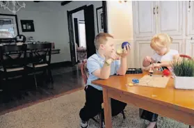  ??  ?? Patrick and Jenna play in their living room. Their parents say that although they still have symptoms of the disease, their quality of life is much better.