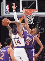  ?? JAYNE KAMIN-ONCEA/USA TODAY SPORTS ?? Suns guard Elie Okobo (2) and forward Mikal Bridges (25) defend Lakers forward Brandon Ingram (14) as he goes up for a basket.