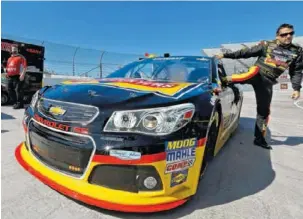  ?? AP
PHOTO Sprint Cup driver Tony Stewart gets out of his car after qualifying for the Sprint Cup race at Martinsvil­le Speedway April 5. GM is using what it learns on the track to improve its vehicles. ??