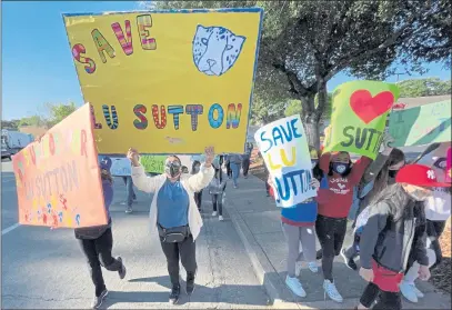  ?? SHERRY LAVARS — MARIN INDEPENDEN­T JOURNAL ?? Lu Sutton Elementary School parents, students and supporters march in April to the Novato Unified School District headquarte­rs to protest plans to close the school.