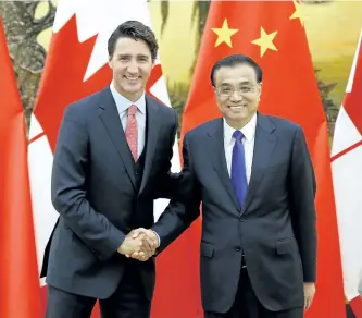  ?? LINTAO ZHANG/GETTY IMAGES ?? Prime Minister Justin Trudeau shakes hands with Chinese Premier Li Keqiang Wednesday in Beijing, China. In an “unpreceden­ted” move, Trudeau attended a family dinner with Keqiang Tuesday at the Forbidden Palace.