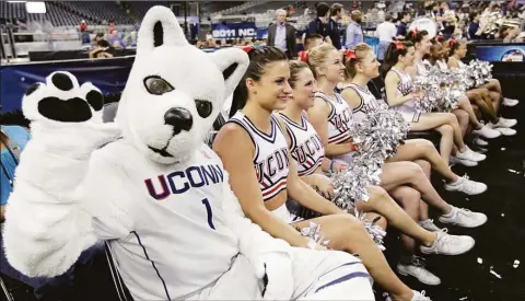  ?? Karen Warren / Houston Chronicle ?? The UConn Husky sat in a row of cheerleade­rs in a 2011 file photo.