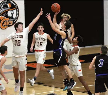  ?? PILOT PHOTO/RUDY MARQUEZ ?? Laville’s Andrew Dill gets this floater off over the hands of Marquez Anderson of Culver during a regular season game this year. The senior Dill will play an important role in the Lancers’ postseason success.