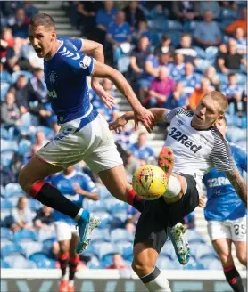  ??  ?? Nikola Katic challenges Derby County’s Martyn Waghorn for the ball