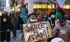  ?? Photograph: Ashlee Rezin Garcia/AP ?? Dozens of protesters march down the Magnificen­t Mile after the city of Chicago released videos of Adam Toledo, 13, being fatally shot by a Chicago police officer, on Thursday evening.