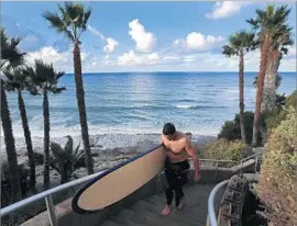  ?? Don Bartletti Los Angeles Times ?? ENCINITAS IS San Diego County’s only city without a state-required housing plan for all income levels. Above, a surfer leaves Encinitas’ Swami’s Beach in 2015.