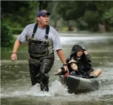  ??  ?? MIDDLE LEFT: People evacuate a neighborho­od Monday in West Houston.