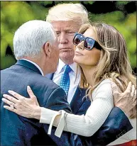  ?? AP/ANDREW HARNIK ?? President Donald Trump and first lady Melania Trump say goodbye to Vice President Mike Pence on Friday at the White House before boarding the helicopter Marine One.