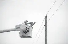  ??  ?? A Central Electric lineman prepares to work on a single phase circuit within the cooperativ­e's service territory.