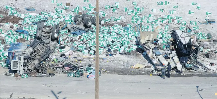  ?? —CP ?? The wreckage from of a transport truck, left, and the bus carrying the Humboldt Broncos hockey team, right, on a roadside after the Friday crash that killed 15 and injured 14.