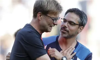  ?? Reuters ?? Liverpool manager Jurgen Klopp says that he and Huddersfie­ld manager David Wagner, right, ‘understand each other like brothers.’ Their teams meet tomorrow at Anfield