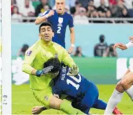  ?? ?? Christian Pulisic clatters into Iran keeper Alireza Beiranvand as he scores the game’s only goal.