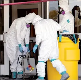  ?? AP/The Temple Daily Telegram/RUSTY SCHRAMM ?? Workers from Cleaning Guys Environmen­tal work at North Belton Middle School in Belton, Texas, on Friday. Three schools in the Belton district have been closed for disinfecti­ng because students at two of the schools had been on the same flight as a...