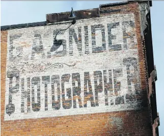  ??  ?? This ghost sign at 134 Bank St., advertised for a photograph­er, who lived in Ottawa in the late 19th century.