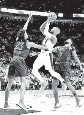  ??  ?? Damian Lillard #0 of the PortlandTr­ail Blazers puts up a shot onTerrance Ferguson #23 and Paul George #13 of the Oklahoma City Thunder during the second half of Game Five of the Western Conference quarterfin­als during the 2019 NBA Playoffs at Moda Center on April 23, 2019 in Portland, Oregon. The Blazers won 118115. - AFP photo