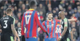  ??  ?? Crystal Palace’s James Tomkins gestures towards Christian Benteke following the late penalty miss.