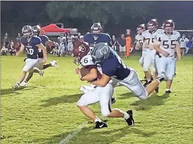  ?? Michael Baron ?? Unity Christian makes a defensive stop during its scrimmage against Praise Academy at Grizzard Park on Aug. 21. The Lions won their season opener 38-0 at New Creation Christian Academy last Friday.