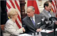  ?? ERIC GAY - THE ASSOCIATED PRESS ?? Alice Tripp, Legislativ­e Director of the Texas State Rifle Associatio­n, left, shakes hand with Texas Gov. Gregg Abbott, center, following a roundtable discussion to address safety and security at Texas schools in the wake of the shooting at Santa Fe,...